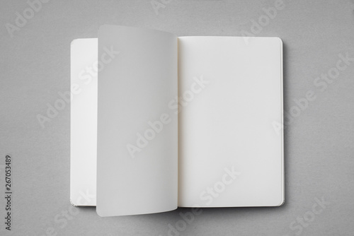 white notebook with turn page on grey background