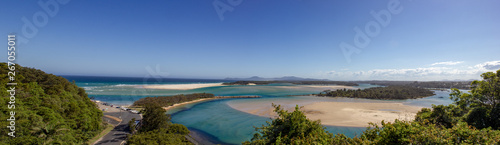 panorama of flat sand dunes at delta of Nambucca river entering Pacific ocean through wide sandy beach of Australian coast around Nambucca heads town - aerial view