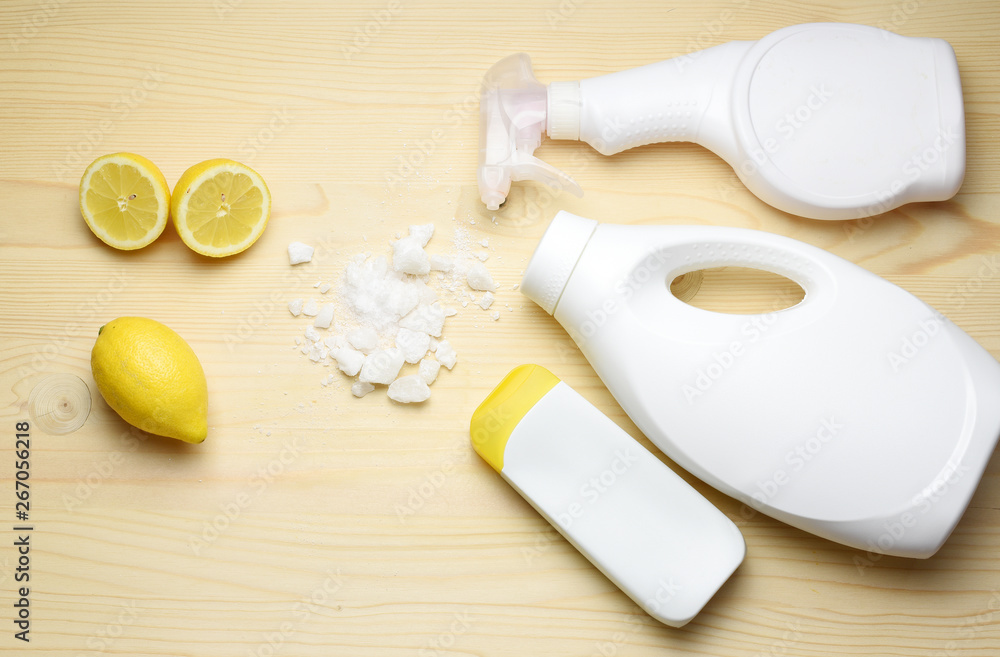 Eco friendly natural cleaners, washing soda, lemon, crystalic salt on a wooden background. Europe, Czech republic, Eco friendly natural cleaners, washing soda, lemon, crystalic salt on a wooden background. Europe, Czech republic,