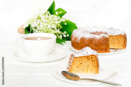 Bundt cake with sugar frosting. Spring breakfast set. Morning tea with flowers. Selected focus