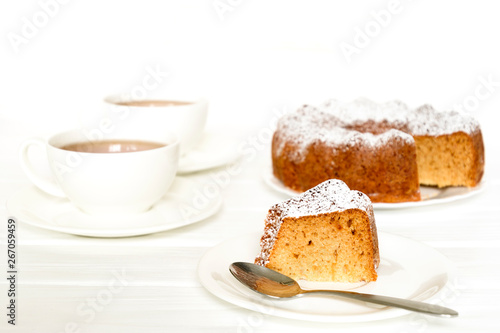 Morning still life with bundt cake and tea on white wooden table. Selected focus