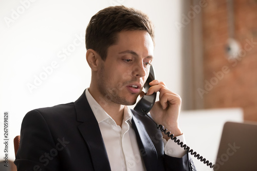 Φωτογραφία Close up of serious businessman talk on phone with client