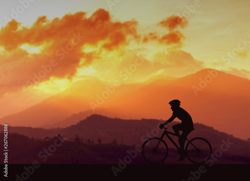 silhouette bike and mountain at sunset background