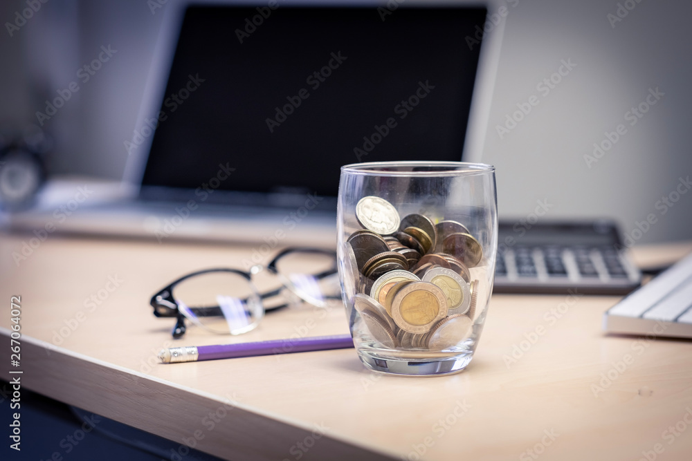 Closeup coin in the glass.concept saving money for finance accounting Closeup coin in the glass.concept saving money for finance accounting
