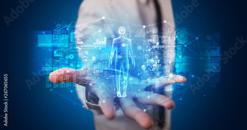 Young person holding hologram projection displaying health related graphs and symbols
