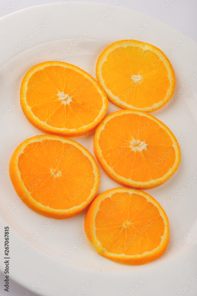 Fresh slised oranges isolated on the gray background Fresh slised oranges isolated on the gray background