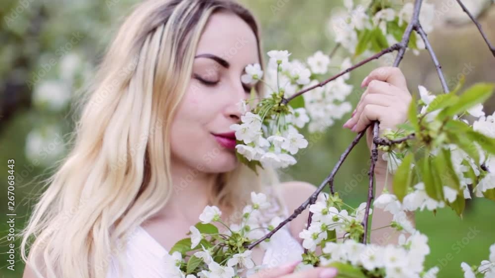 Woman enjoying spring flowering gardens. Closeup portrait. Woman enjoying spring flowering gardens. Closeup portrait.