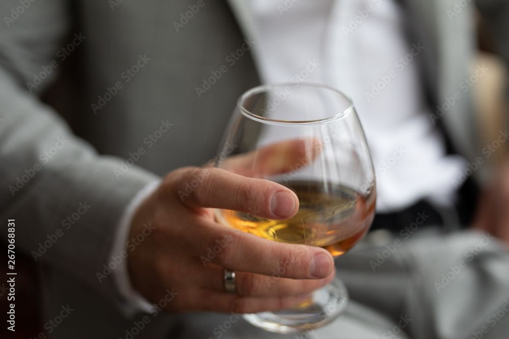 a glass of whiskey in the hands of a man a glass of whiskey in the hands of a man
