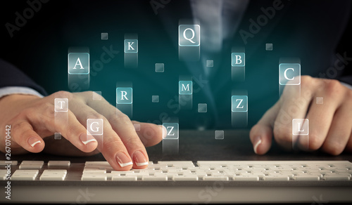 Business woman typing on keyboard with letters around
