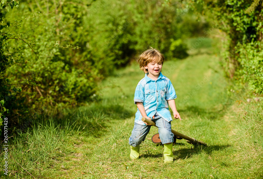 small kid play with shovel. ecology and environmental protection. earth day. farming equipment. summer fun. happy child gardener. spring country side village. little kid having fun. nature and human small kid play with shovel. ecology and environmental protection. earth day. farming equipment. summer fun. happy child gardener. spring country side village. little kid having fun. nature and human