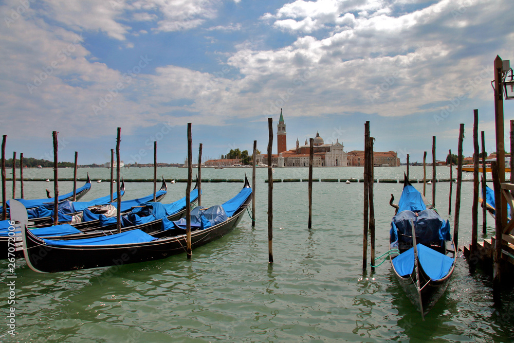 Venice, Veneto / Italy: Gondolas in front of the Palazzo Ducale with San Giorgio Maggiore Church in the distance