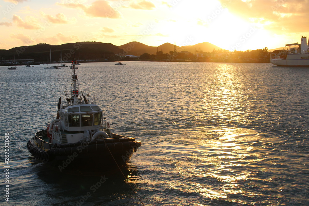 sunset with a tug boat