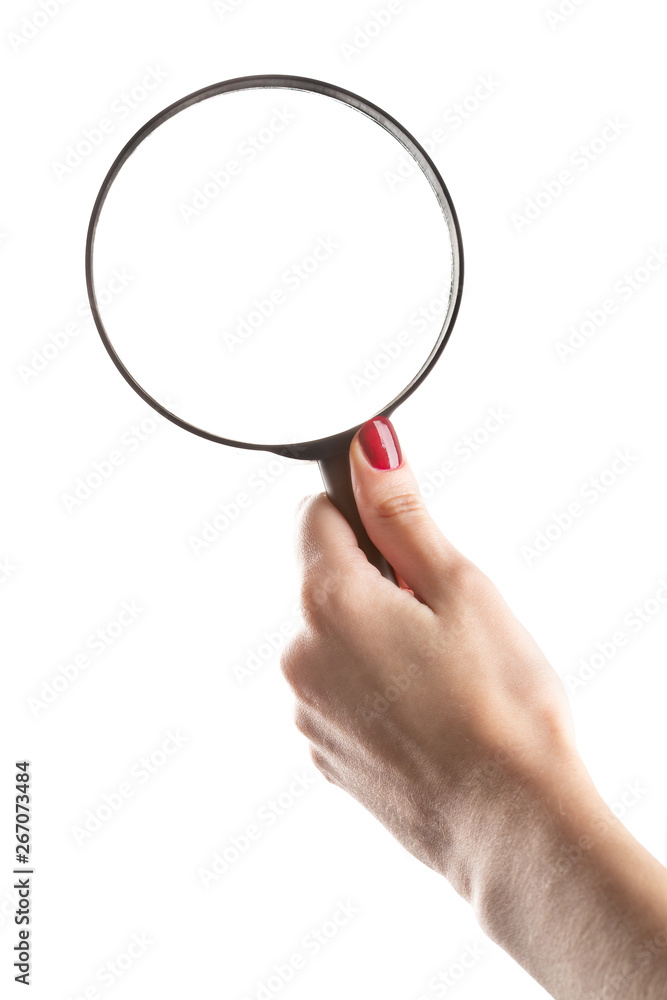 Female hand holding magnifying glass isolated on white background. Female hand holding magnifying glass isolated on white background.