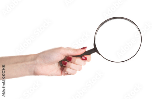 Female hand holding magnifying glass isolated on white background.