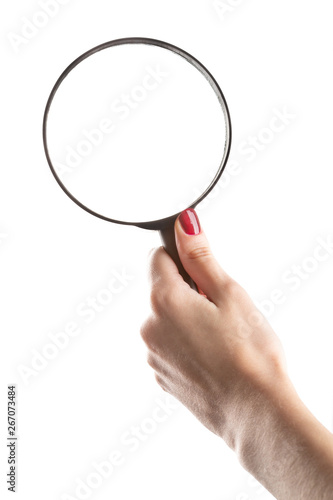 Female hand holding magnifying glass isolated on white background.