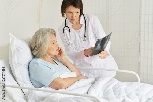 Photography Portrait of senior woman portrait in hospital with caring doctor