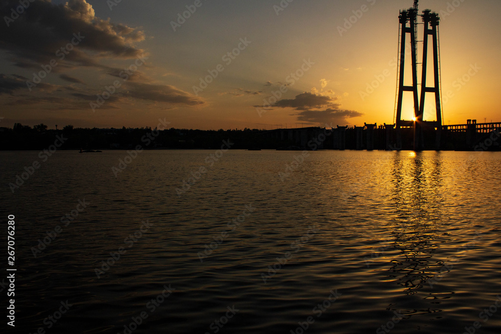 Sunset over the river Dnieper. Bridge.