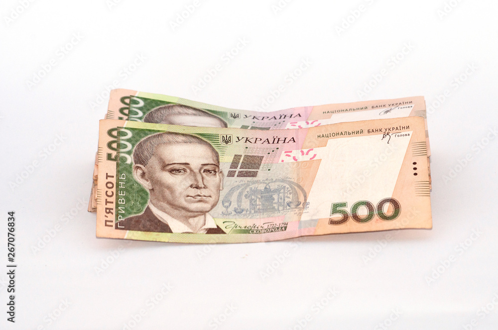 Money Ukrainian hryvnia on a white background, a large bundle of bills Money Ukrainian hryvnia on a white background, a large bundle of bills
