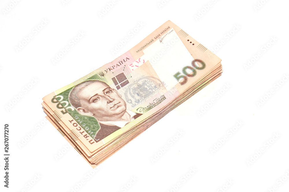 A pile of Ukrainian money for five hundred hryvnia isolated on a white background. Top view, copy space. A pile of Ukrainian money for five hundred hryvnia isolated on a white background. Top view, copy space.