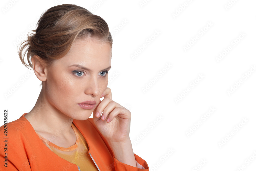 Portrait of thoughtful young woman in orange jacket on white background Portrait of thoughtful young woman in orange jacket on white background