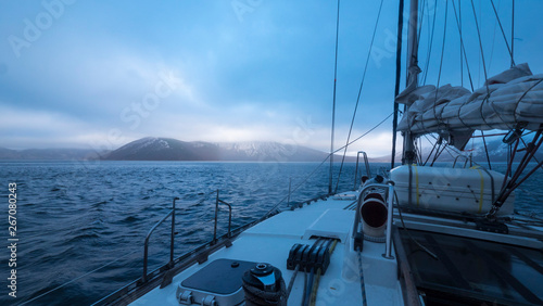 View of mountains with snow caps on the top from boat. © DmitriiStepanov