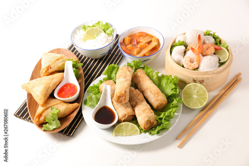selection of asian meal with spring roll, samossa, fried noodles, soup