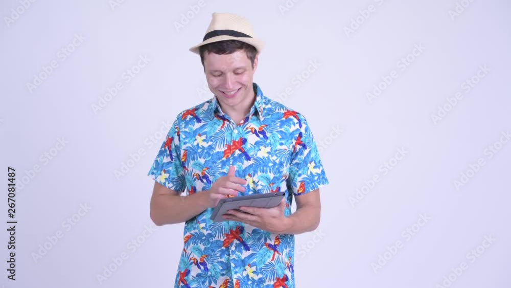 Happy young handsome tourist man thinking while using digital tablet Happy young handsome tourist man thinking while using digital tablet
