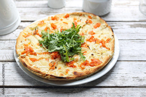 Pizza with tomatoes, mozzarella and rocket salad.