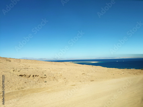 Desert land with mountains and sea © Studio-M