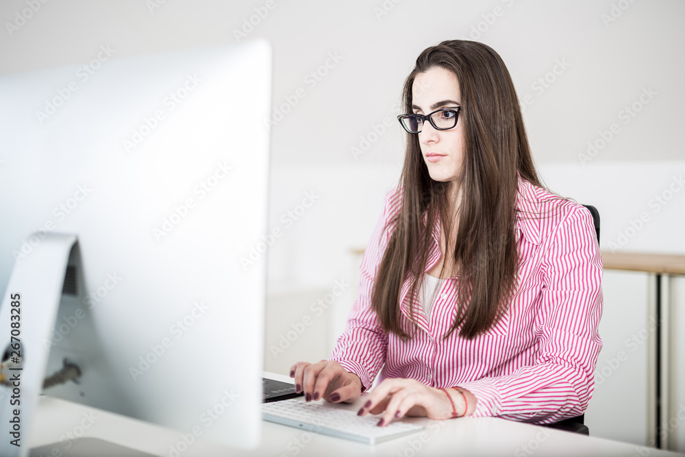 Portrait of young female graphic designer creative working on her computer. Portrait of young female graphic designer creative working on her computer.