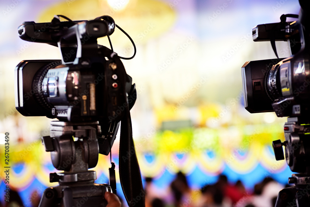 Video journalist capturing moving picture by camcorder in a event
