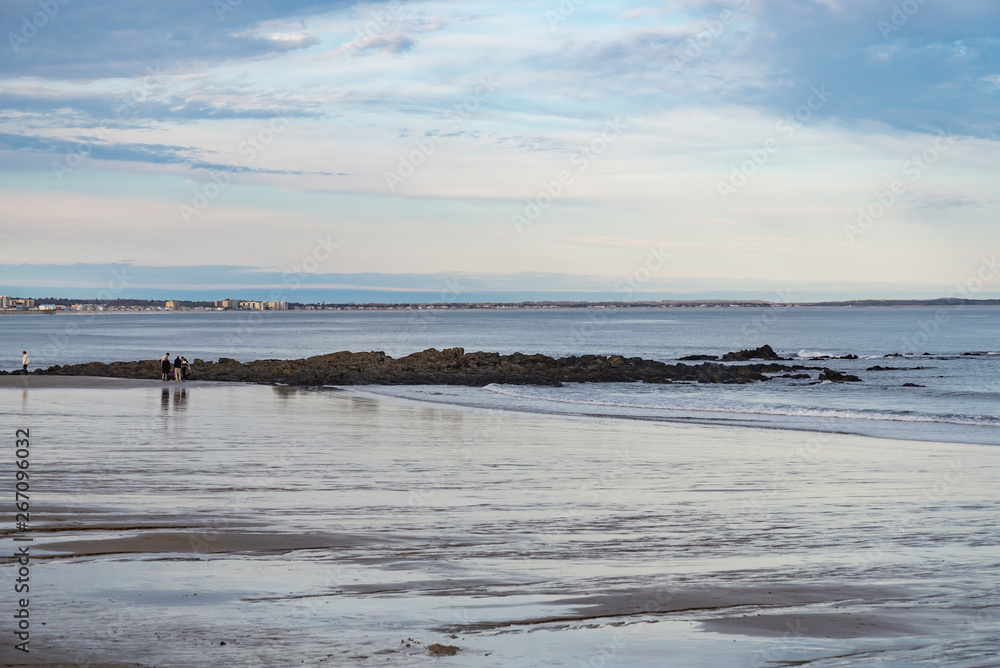 People walk on the beach in Maine, USA People walk on the beach in Maine, USA
