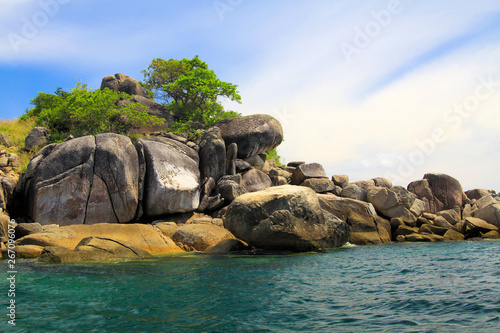 Isolated tiny island of rocks and boulders in Andaman Sea near Ko Lipe, Thailand