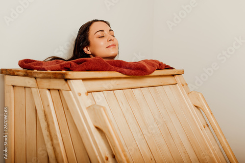 Tablou pe pânză smiling woman taking steam bath with closed eyes in spa center