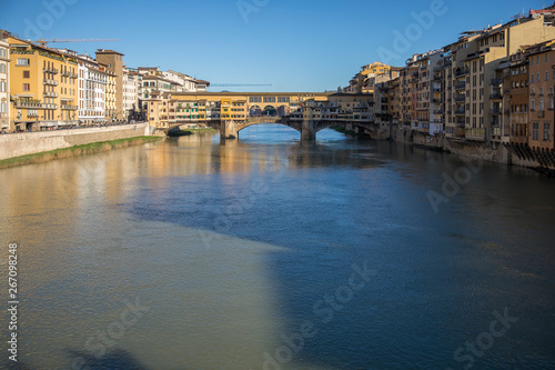 Sunny view on the Arno River and Ponte Vecchio in Florence, Italy