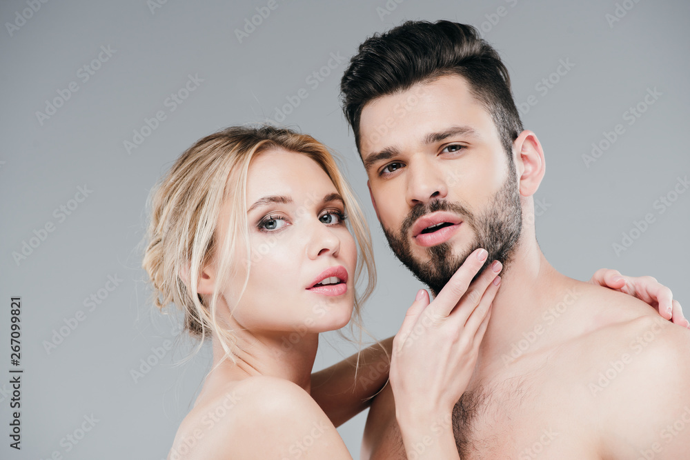 nude young woman touching face of handsome bearded man on grey nude young woman touching face of handsome bearded man on grey