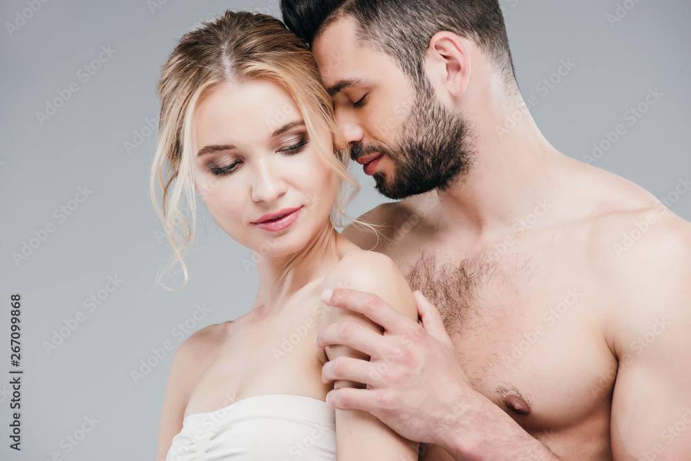 shirtless bearded man touching attractive blonde young woman on grey shirtless bearded man touching attractive blonde young woman on grey