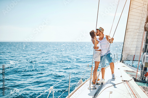 Man and woman in love on a sail boat in the summer.
