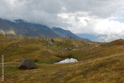 Tent near mountain lake. Tourist traveler with backpack. Svaneti. Georgia