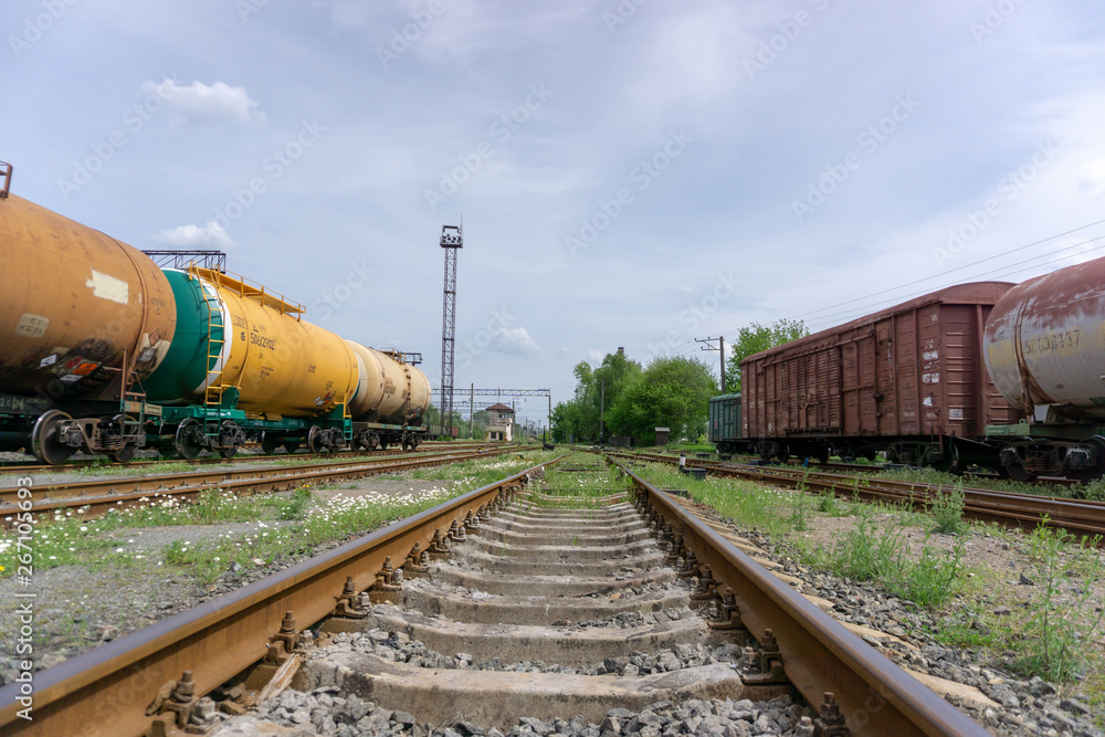 The train passes on a railway through the city, sunny day with blue sky and clouds. Kyiv(Kiev), Ukraine. The train passes on a railway through the city, sunny day with blue sky and clouds. Kyiv(Kiev), Ukraine.