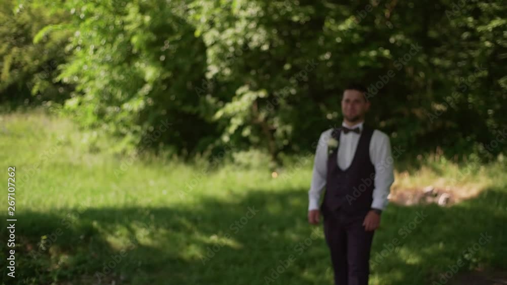 Groom comes to charming blonde bride with bouquet behind her. Slow motion Groom comes to charming blonde bride with bouquet behind her. Slow motion