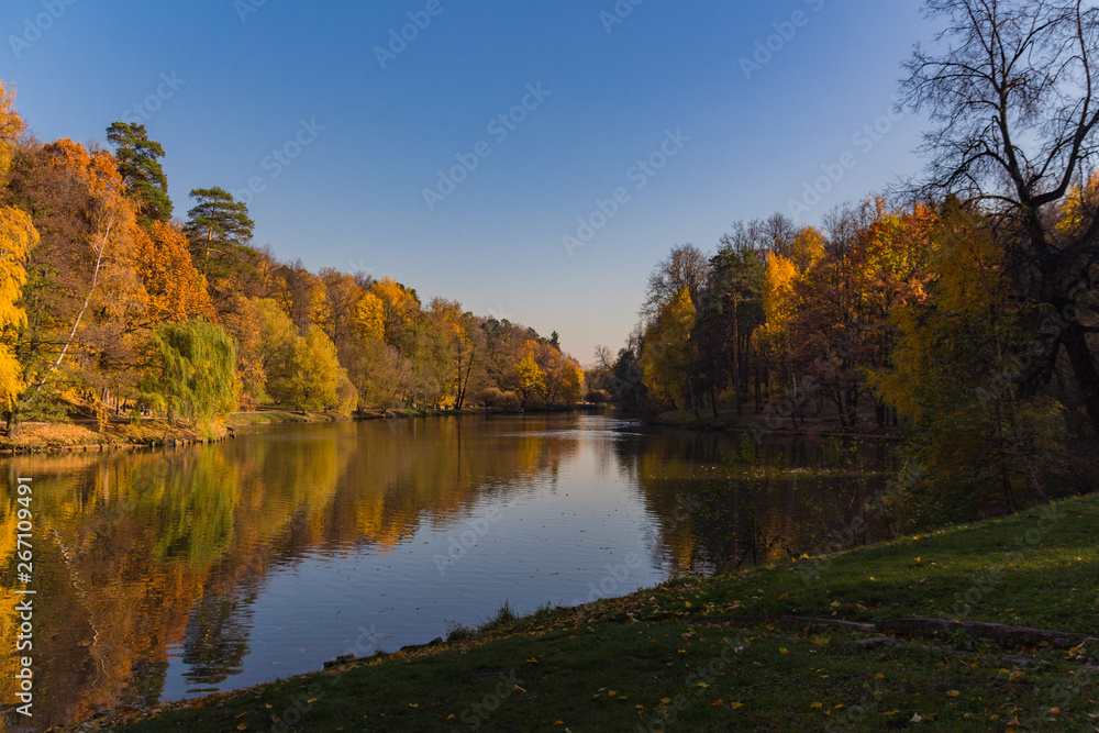 Scenic view to the autumn park and pond Scenic view to the autumn park and pond
