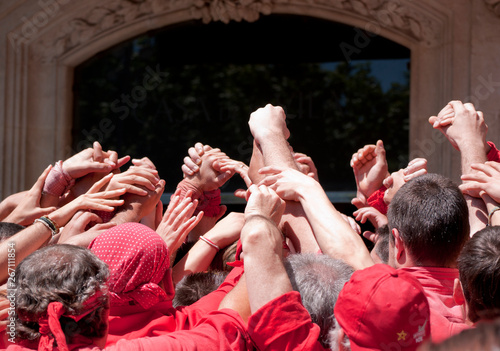 Joined hands to human tower.  Human Tower, typical tradition of Catalonia.