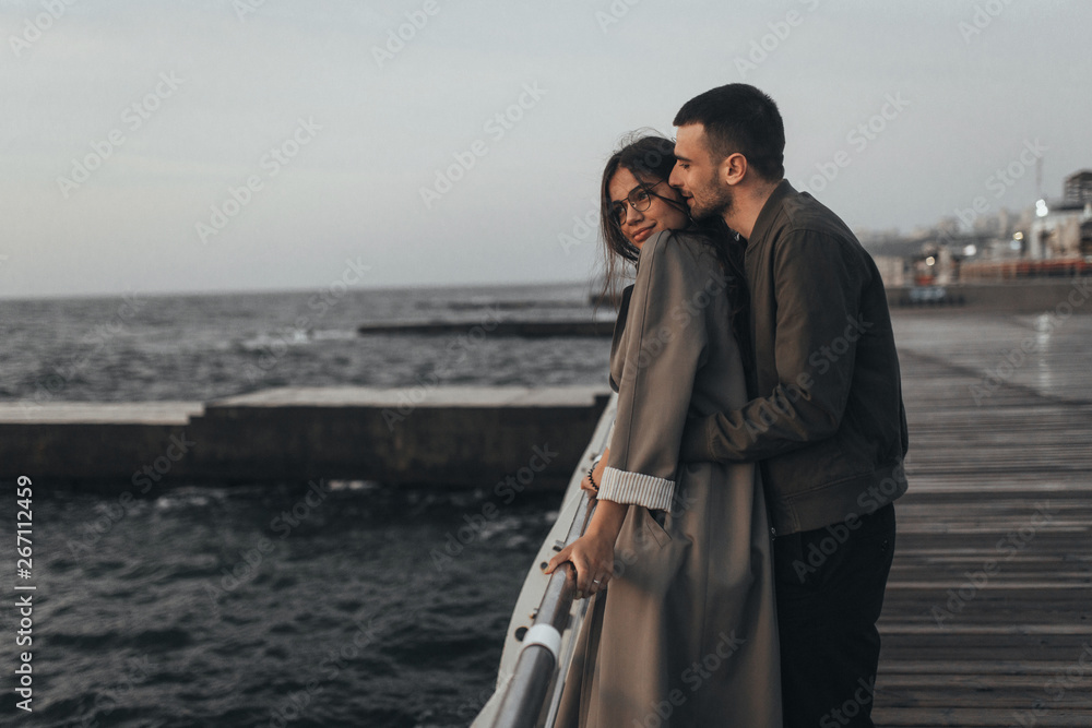 Beautiful loving couple walking at sunset, authentic love Beautiful loving couple walking at sunset, authentic love