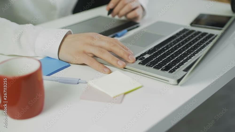 Graphic designer using graphics tablet while working on a logo design Graphic designer using graphics tablet while working on a logo design