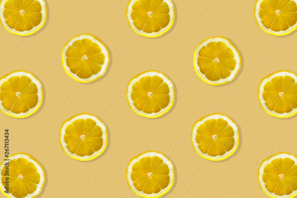 Creative pattern made of lemon. top view of fruit fresh limes slices on orange & yellow colorful background.