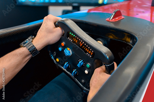 Man playing a racing video game - driving f1 simulator © bennian_1