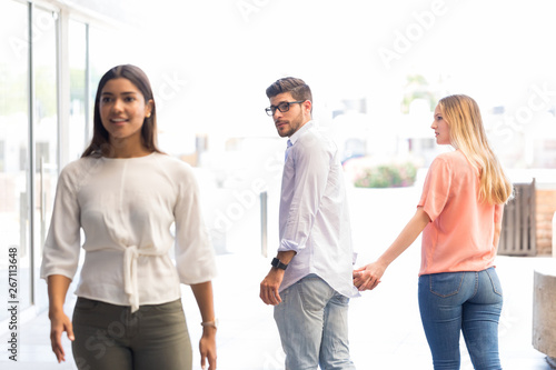 Картината върху платно Man checking out another woman while walking with his girlfriend