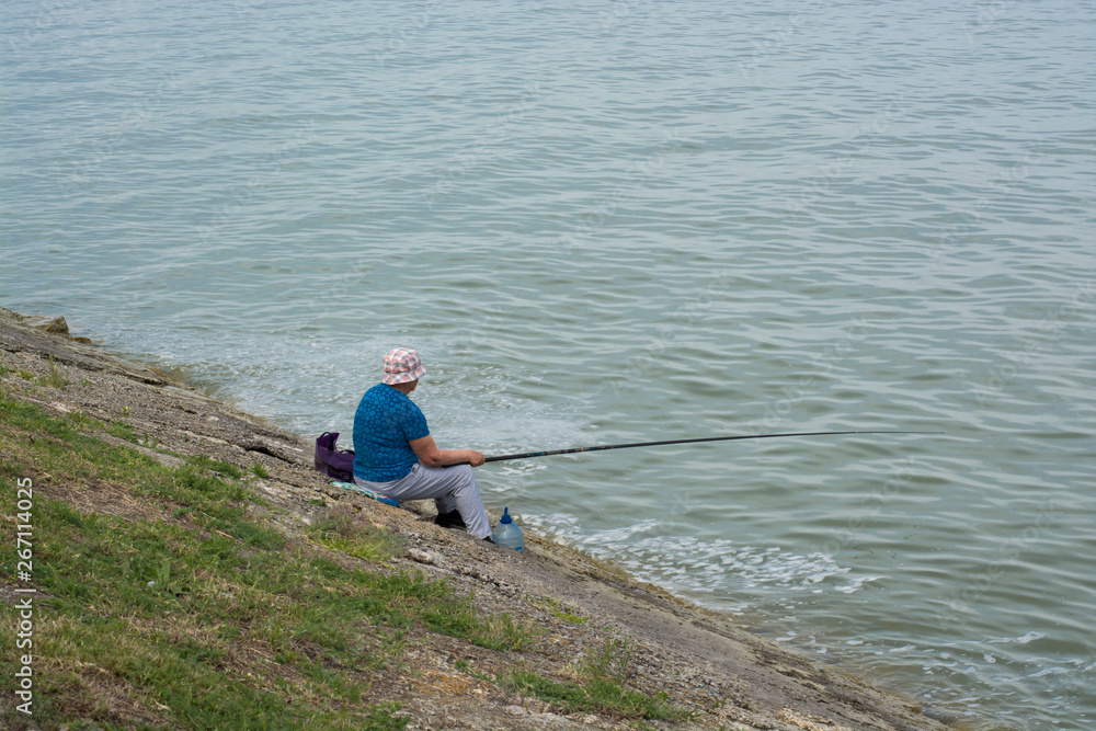 Woman fishing on shore