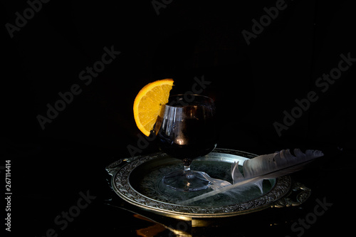 Wallpaper Mural On a silver tray is a glass of red wine with an orange slice on the edge. Nearby is a goose feather. Concept - a mysterious evening Torontodigital.ca